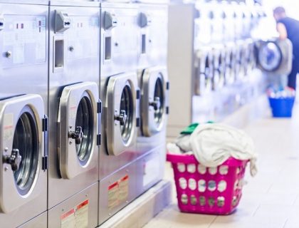 Industrial washing machines in a public laundromat.
